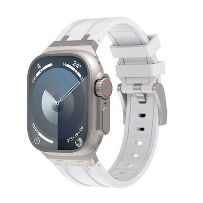 A metallic smartwatch with a square case and a white silicone strap featuring a silver buckle, displayed against a white background.