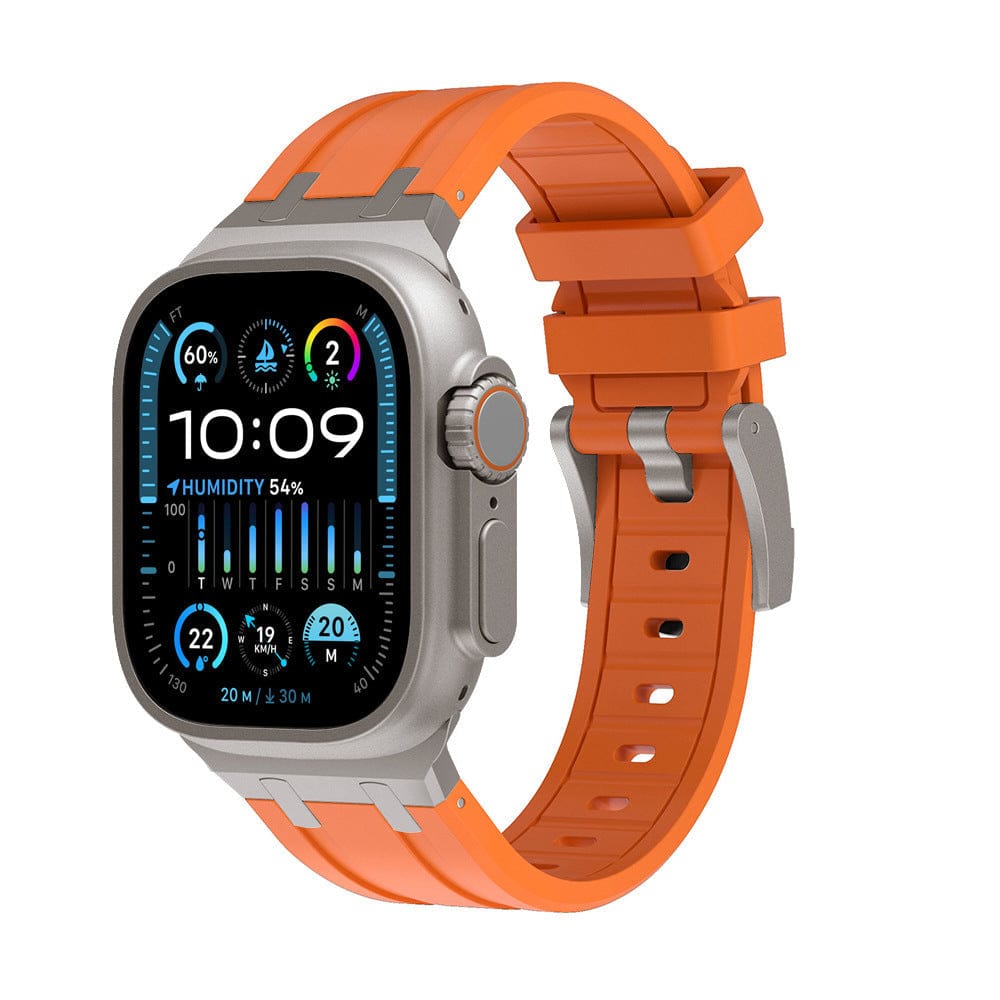 A smartwatch with a rectangular display showing a digital interface sits attached to a bright orange silicone band with a metal buckle.