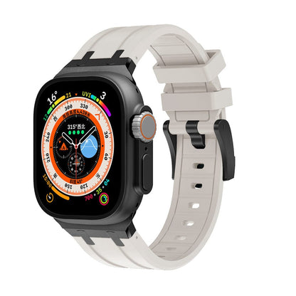 A smartwatch featuring a black rectangular case with a circular dial display and a light beige silicone strap with a black buckle.