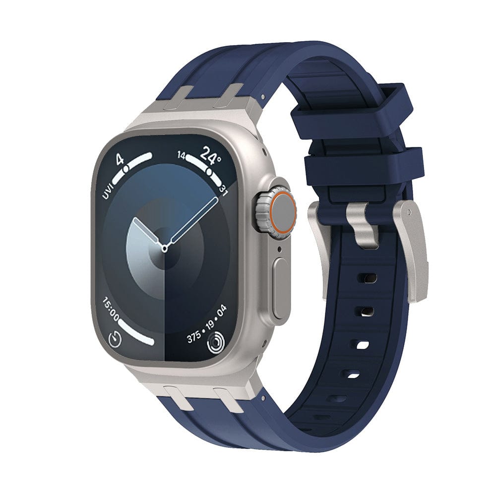 A smartwatch with a rectangular silver case, a dark blue silicone watch band, and a digital watch face displaying circular complications.
