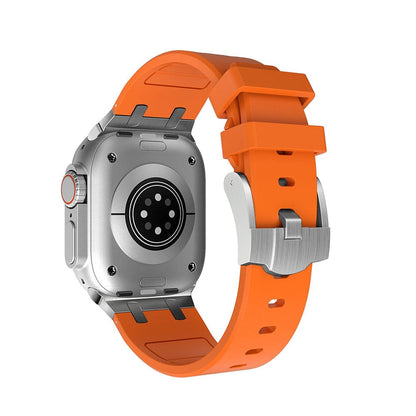 A silver-toned smartwatch with a circular sensor array on the back and a bright orange silicone strap with a metal buckle.