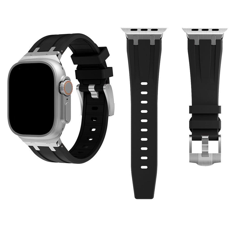 A black silicone replacement strap for a smartwatch is shown with a watch face attached on the left and two separate strap components on the right, all featuring silver metal connectors and buckles.