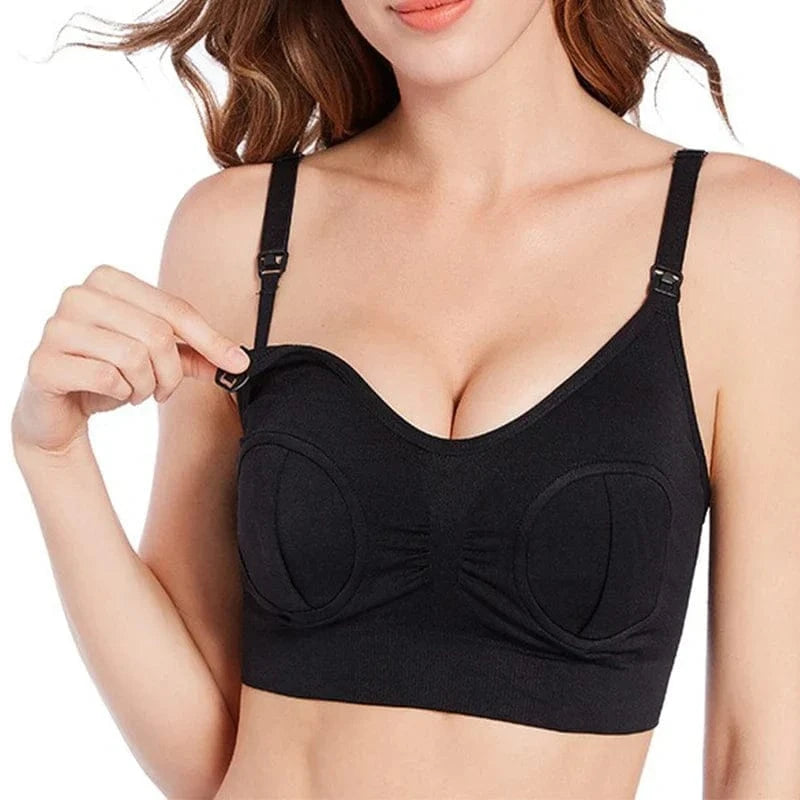 A black wireless nursing bra worn by a person, featuring adjustable shoulder straps with release clips at the top of each cup for breastfeeding access.
