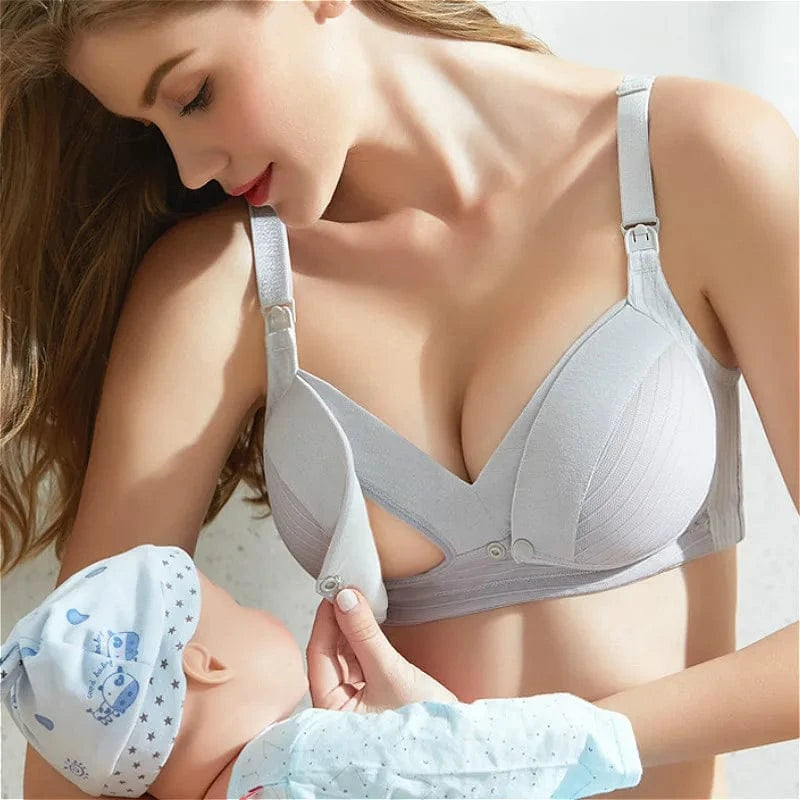 A light grey nursing bra with a convenient front-opening clip feature, worn by a woman holding a baby.