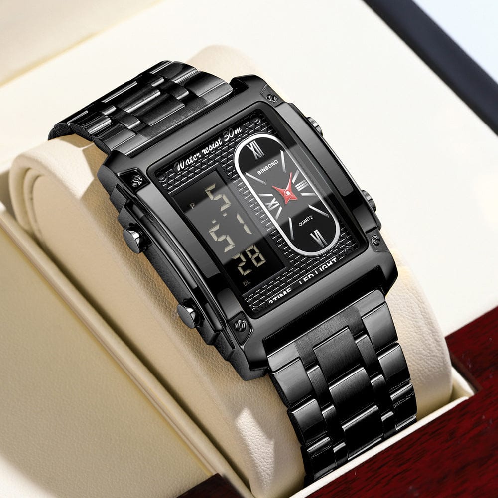 A rectangular black metal wristwatch features a hybrid analog and digital display, set within a padded watch box.