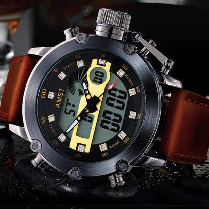 A metallic sports watch featuring a black analog-digital dial with gold accents, luminous hands, and a brown leather strap resting on a dark reflective surface.