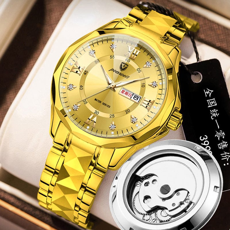 A gold-toned wristwatch with a faceted link band, a round dial featuring crystal hour markers, and a date display, accompanied by a small circular mechanical gear display in the foreground.