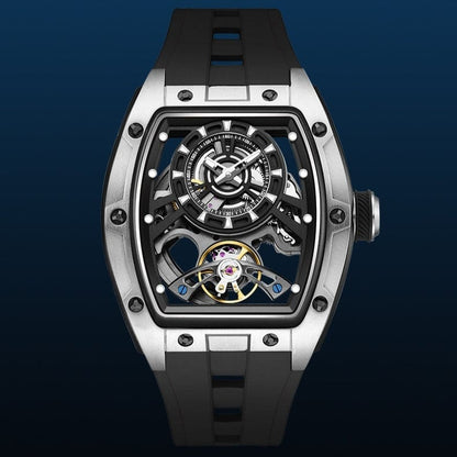 A skeleton watch featuring a tonneau-shaped silver-tone case, a black dial with exposed mechanical movement components, and a black textured rubber strap against a dark blue background.