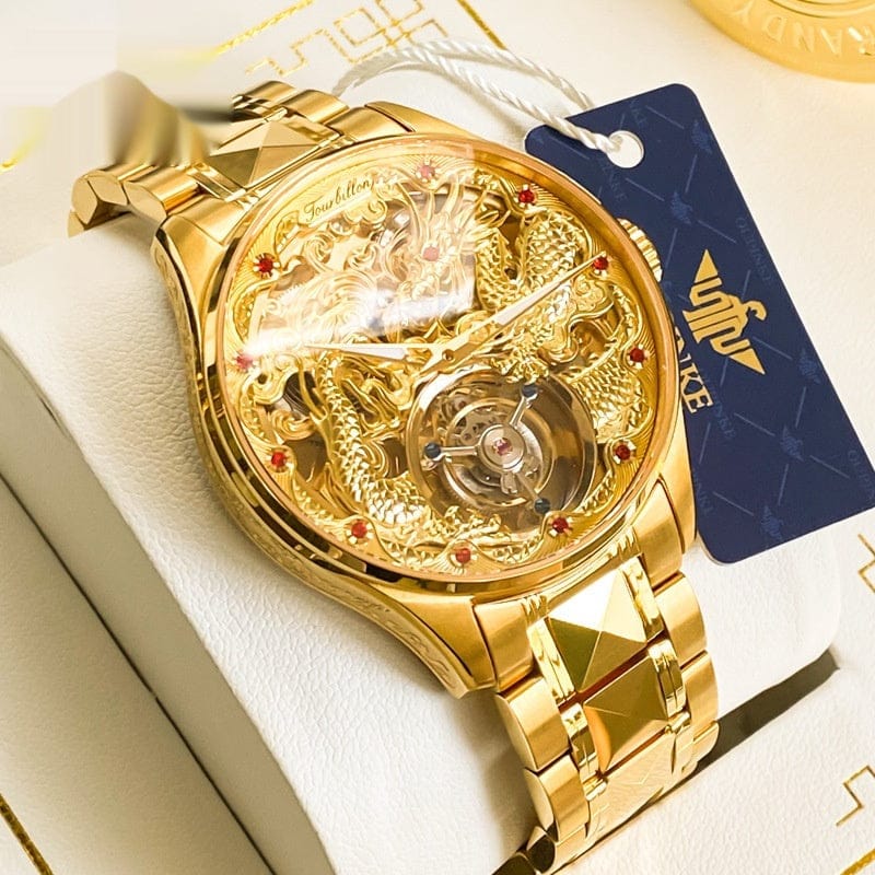 A gold-toned wristwatch featuring a skeleton dial with an intricate embossed dragon design and a mechanical tourbillon movement, secured by a matching faceted link bracelet.