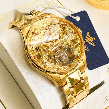 A gold-toned wristwatch featuring a skeleton dial with an intricate embossed dragon design and a mechanical tourbillon movement, secured by a matching faceted link bracelet.