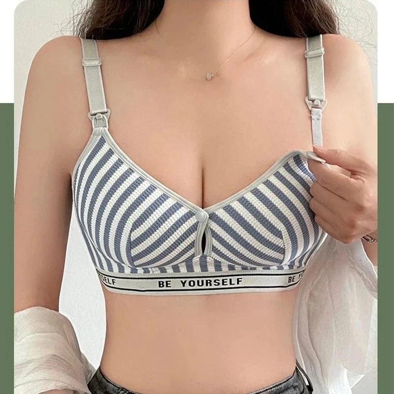 A striped blue and white nursing bra featuring adjustable straps and a band with the text BE YOURSELF worn by a person.