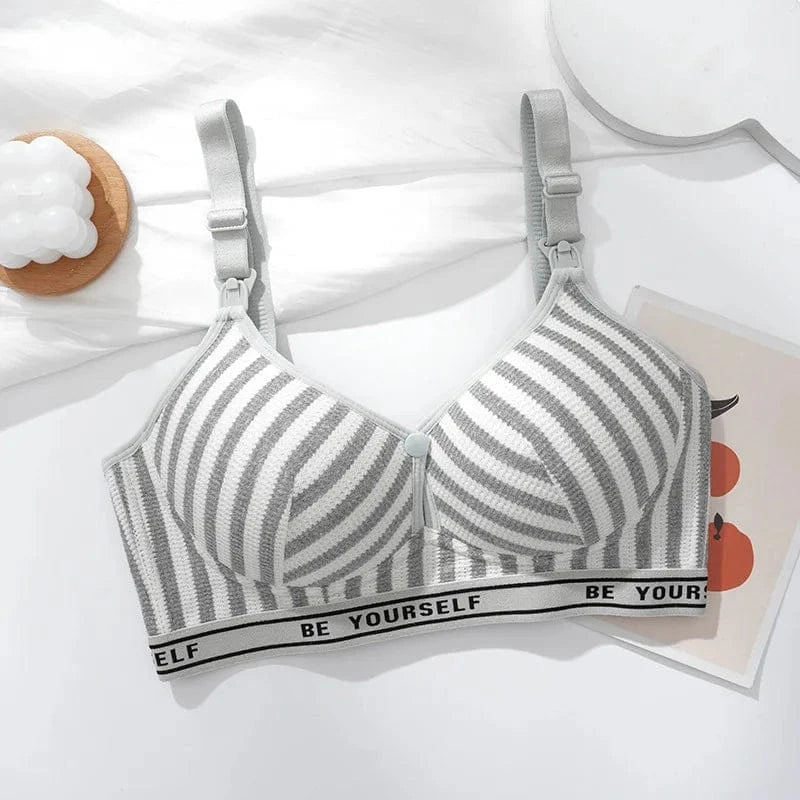 A grey and white striped nursing bra with adjustable shoulder straps and a black elastic band featuring the text BE YOURSELF in white lettering.