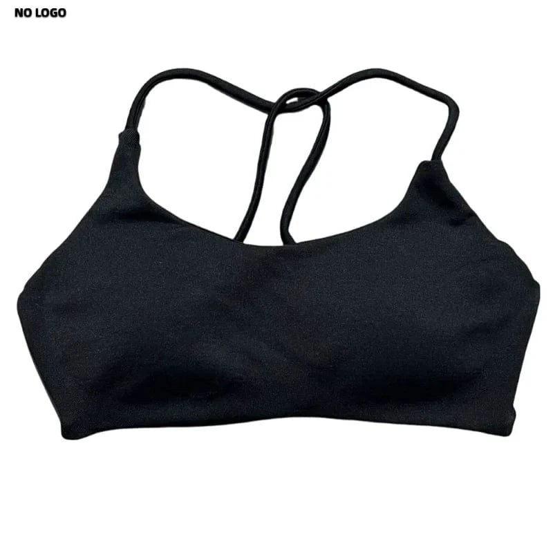 A black sports bra with a scooped neckline and thin crisscross straps on the back against a plain white background.