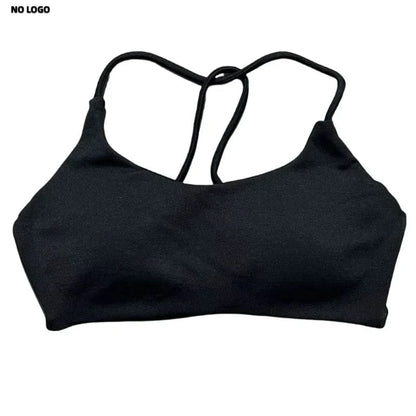 A black sports bra with a scooped neckline and thin crisscross straps on the back against a plain white background.