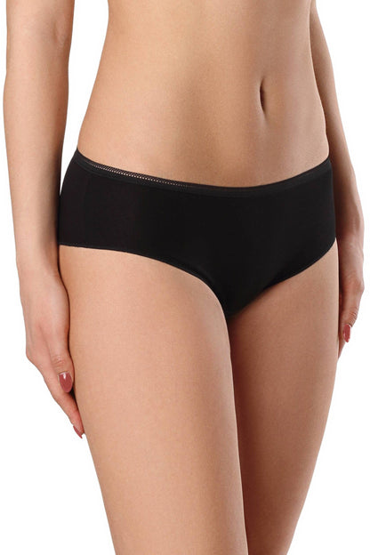 Solid black hipster panties worn by a woman with her hands placed at her hips against a plain white background.