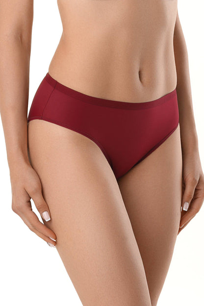 A pair of solid deep red bikini-style underwear worn on a woman's lower torso against a white background.