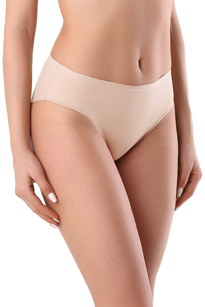 Nude-colored bikini-cut panties with a seamless construction on a model's hips.