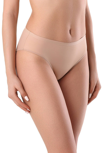 A woman wearing beige seamless bikini-style underwear against a plain white background.