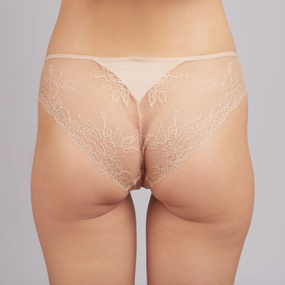 Beige lace panties with a smooth fabric waistband worn from behind on a person.