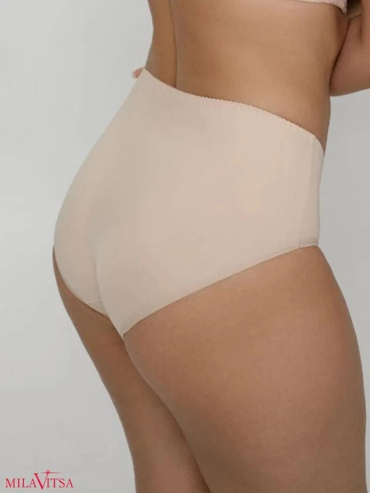 High-waisted beige briefs worn by a person, featuring a smooth seamless design with a scalloped edge along the waist.