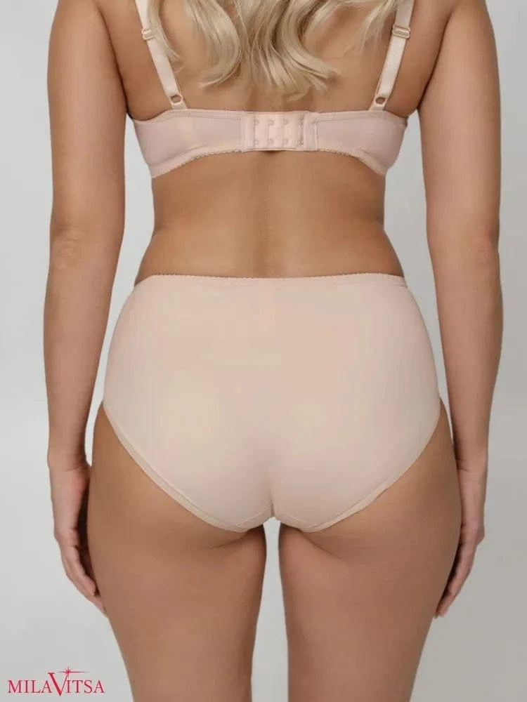 Beige high-waisted briefs seen from the back on a person wearing a matching bra.