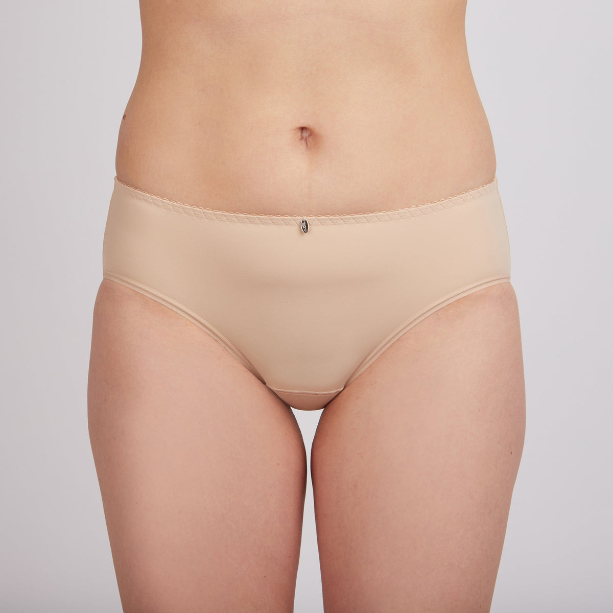 Nude-colored women's bikini-cut underwear featuring a decorative small charm centered on the scalloped waistband.