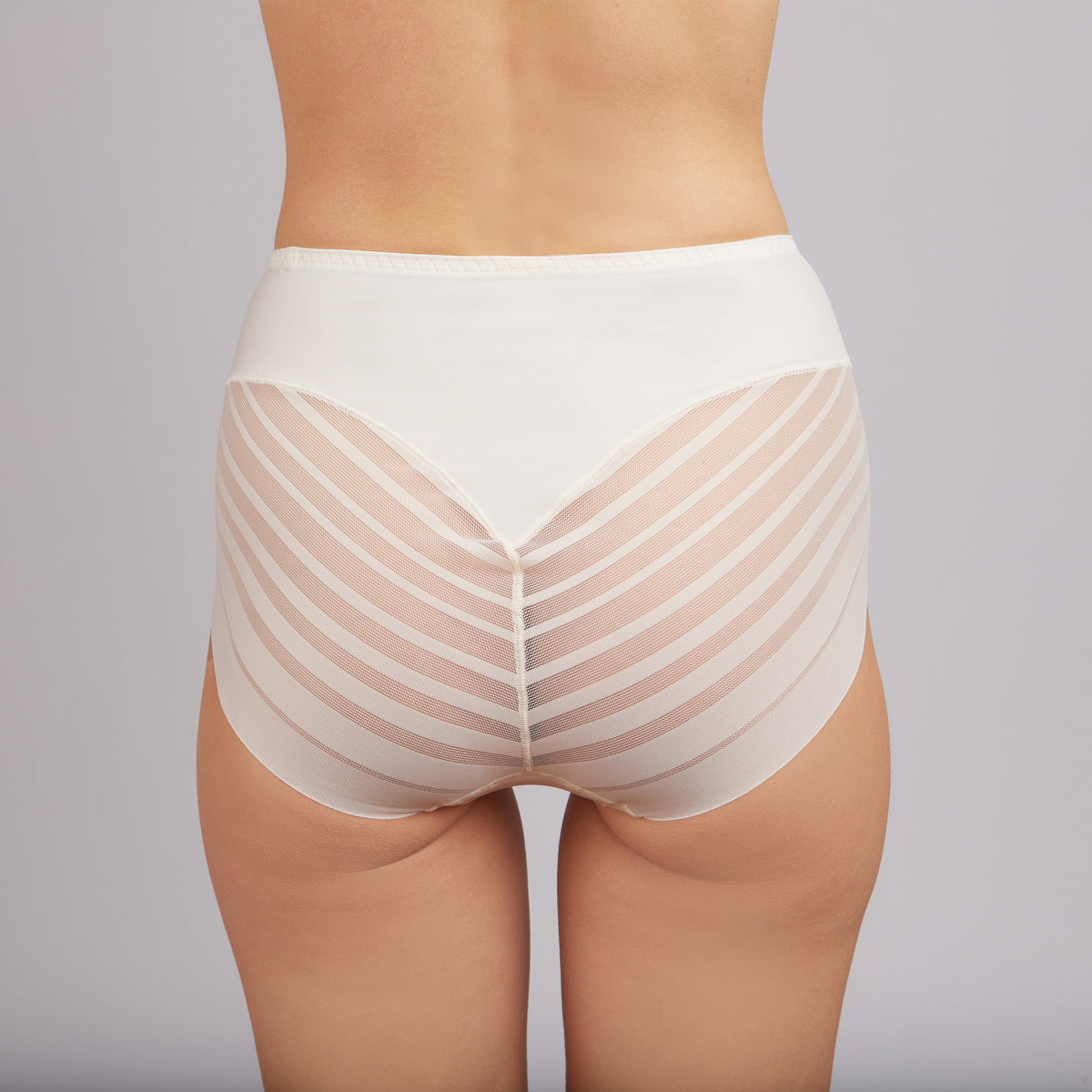 A back view of white high-waisted briefs featuring a sheer, striped mesh fabric on the sides and rear with a solid fabric panel at the top.