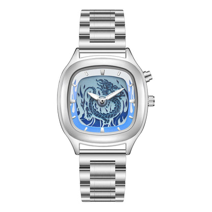 A silver-toned wristwatch features a rounded square case with a light blue dial showcasing a detailed dragon motif and a metal link bracelet.
