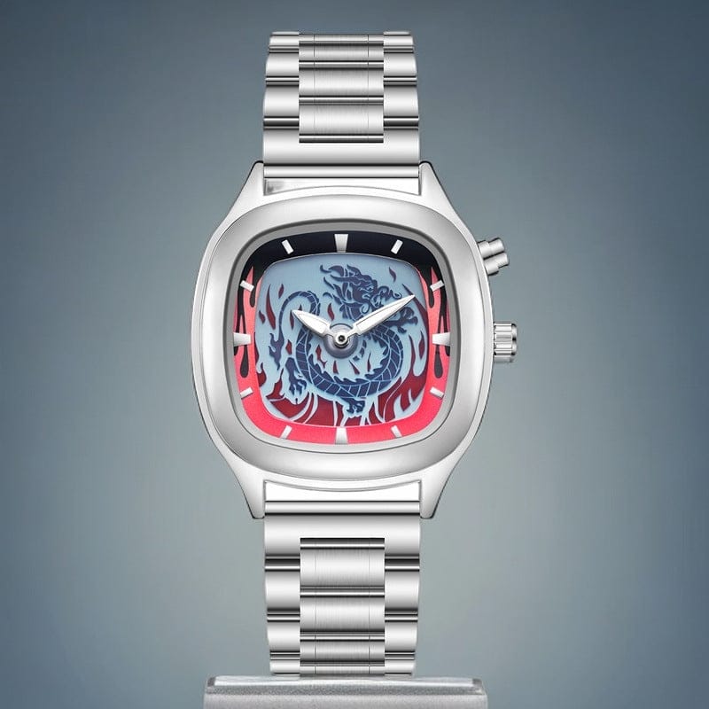 A silver-toned stainless steel watch features a rectangular case with rounded edges, a blue dragon illustration surrounded by red flame-like designs on the dial, and a matching metal link bracelet.
