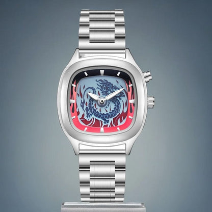 A silver-toned stainless steel watch features a rectangular case with rounded edges, a blue dragon illustration surrounded by red flame-like designs on the dial, and a matching metal link bracelet.