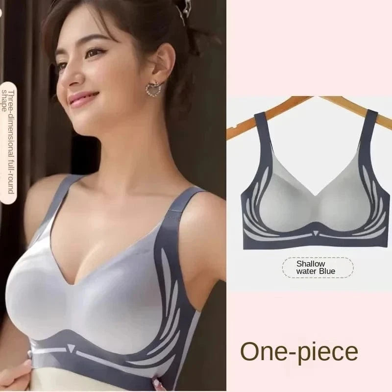 A shallow water blue, one-piece, seamless bra with a wing-like graphic design on the side panels, shown both on a model and on a hanger.