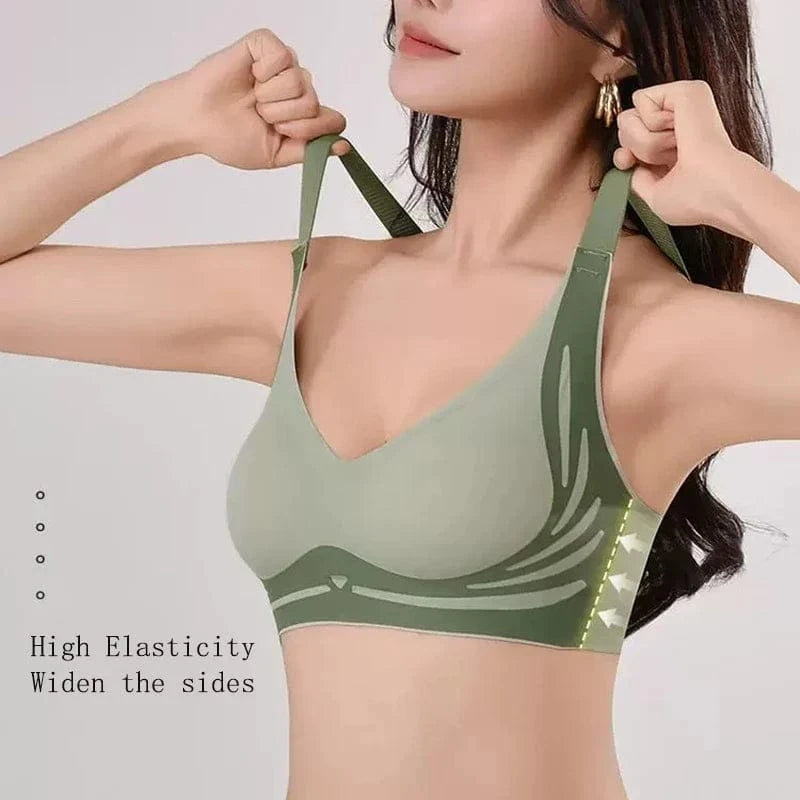 A sage green V-neck sports bra with wide adjustable shoulder straps and reinforced side panels on a woman.