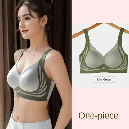A woman wearing a mint green, one-piece seamless bra featuring a V-neckline and decorative wing-like patterns along the sides.