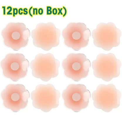 Twelve flower-shaped, skin-toned silicone nipple covers are arranged in a four-by-three grid on a white background, with text at the top indicating there is no box included.