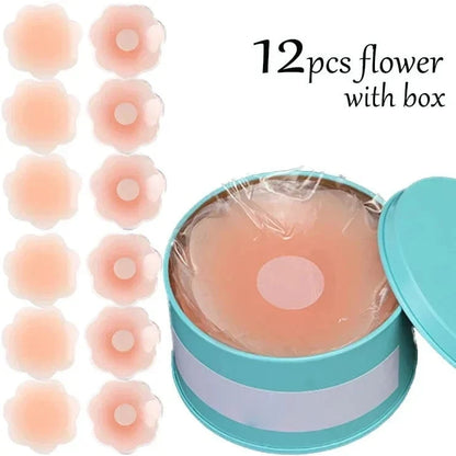 Twelve flower-shaped, nude-colored adhesive nipple covers are displayed next to a teal circular tin container filled with the covers.