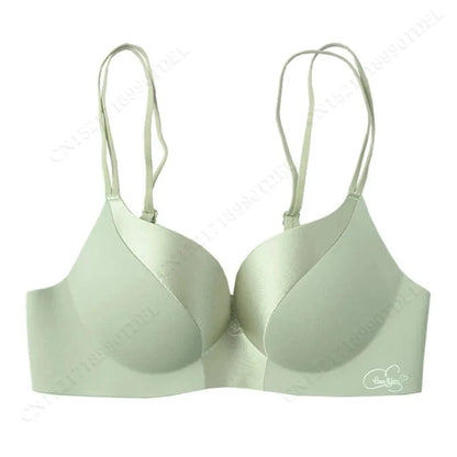 A sage green underwire bra features double spaghetti straps, molded cups, and a small white circular logo on the lower right band.