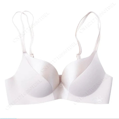 A beige-colored seamless underwire bra featuring double spaghetti straps and a smooth, molded cup design.
