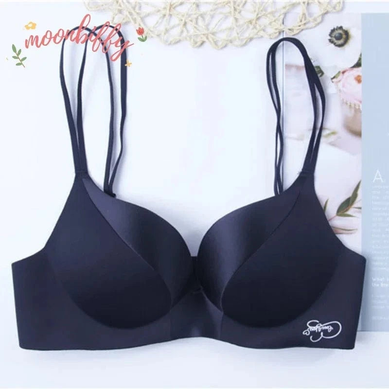 A black wireless bra with double shoulder straps and a small white "Love You" embroidery on the lower right side against a white background.