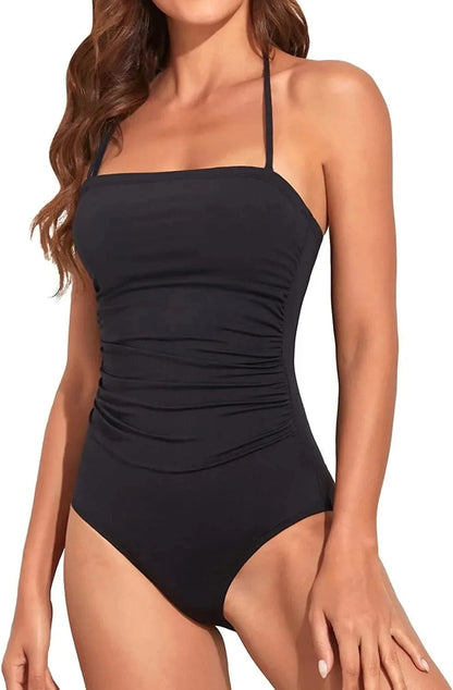 A black one-piece swimsuit features a straight neckline with thin halter straps and gathered ruched detailing along the sides.