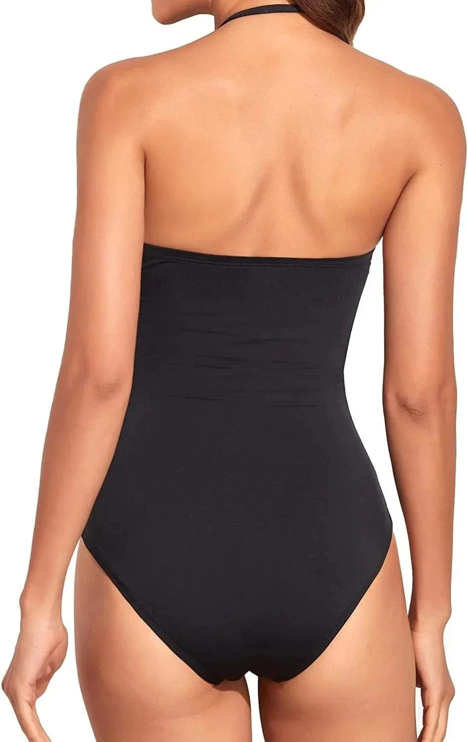 A back view of a person wearing a solid black strapless one-piece swimsuit with thin halter straps.