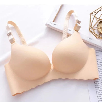 A beige seamless wireless bra featuring lightly padded cups and adjustable shoulder straps against a white background.