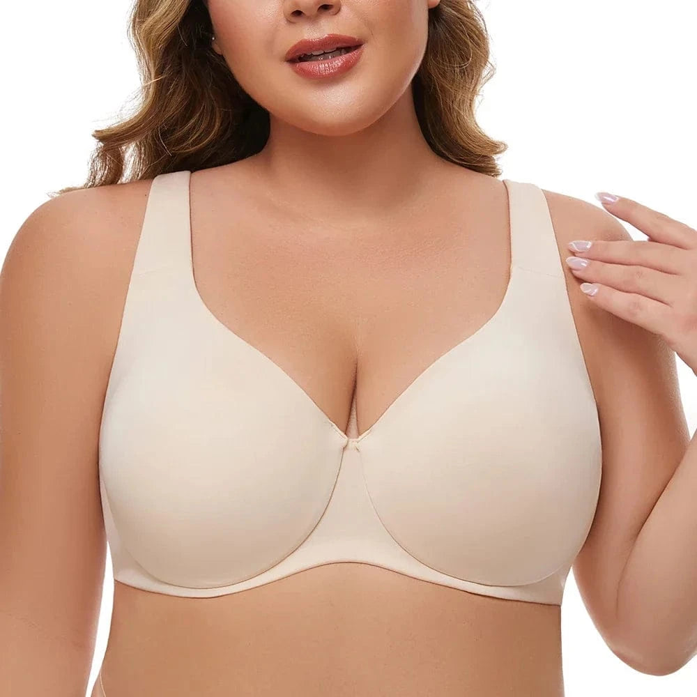 A beige full-coverage bra with wide straps worn by a person.