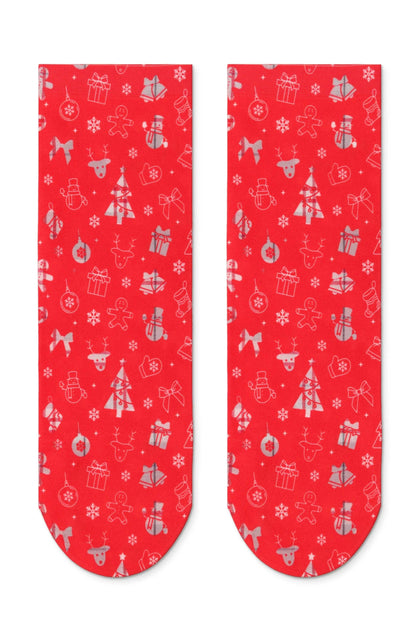 A pair of red ankle socks featuring an all-over white patterned print of Christmas icons including snowflakes, gingerbread men, reindeer, ornaments, gifts, and trees.