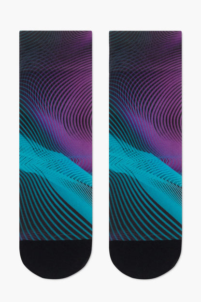 A pair of crew socks featuring a vibrant abstract pattern of purple and turquoise wavy lines set against a black background with solid black heel and toe panels.