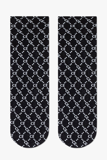 A pair of black crew socks featuring a repeated white grid pattern composed of the letters CE and dots on a dark background.
