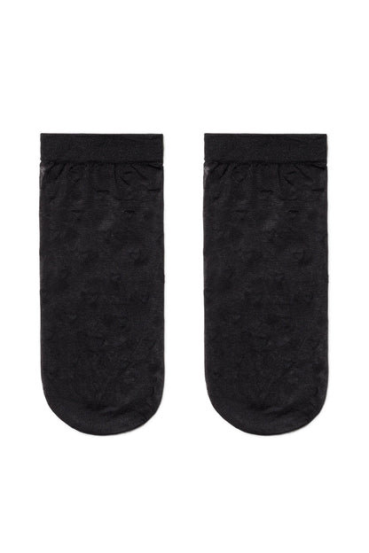 A pair of sheer black ankle socks with a subtle patterned texture laid flat against a white background.