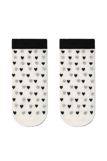 A pair of white sheer ankle socks featuring a repeating pattern of small black and grey hearts with a solid black trim at the cuffs.