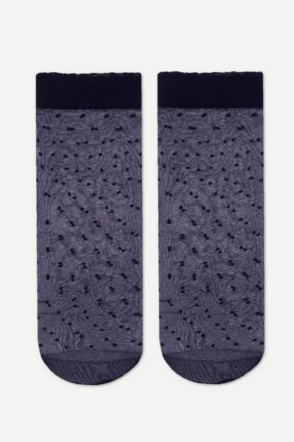 A pair of sheer, navy blue ankle socks featuring a textured dotted pattern and a solid dark cuff with a ruffled edge.