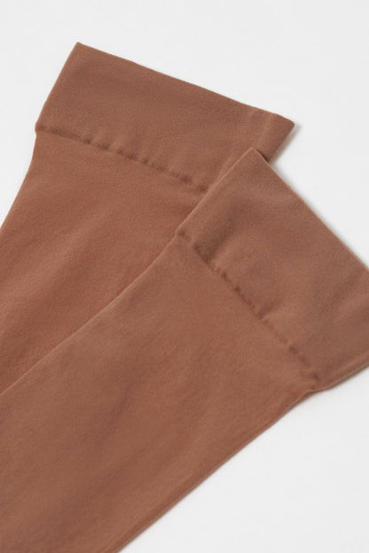 A pair of sheer brown knee-high stockings with wide, reinforced top bands against a plain white background.