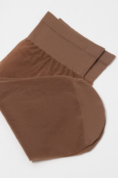 A pair of folded brown sheer stockings featuring a wide, reinforced cuff resting against a plain white background.